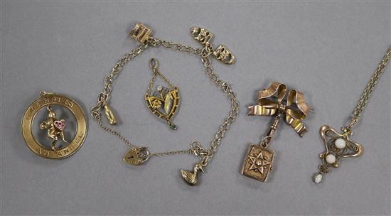 A 9ct gold charm bracelet, a ribbon brooch suspending a book shaped locket, a white opal set Art Nouveau design pendant